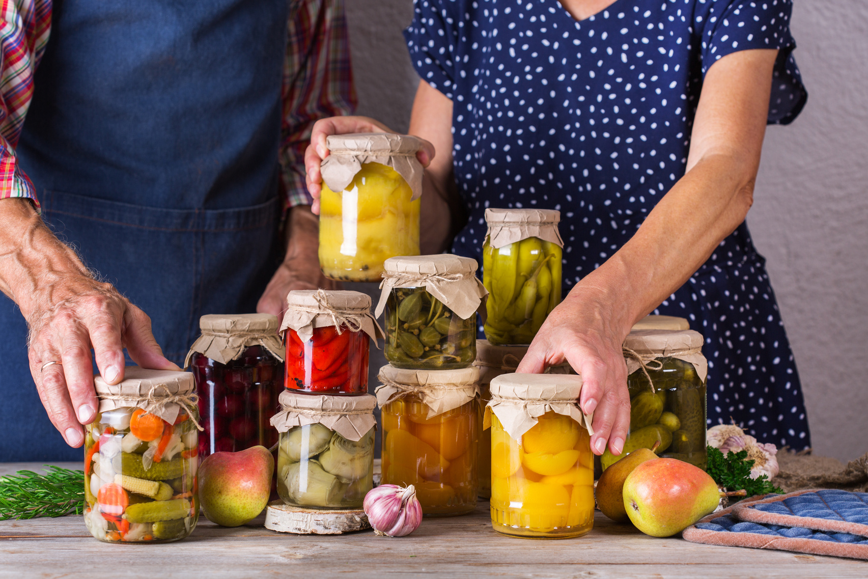 Senior Couple Holding in Hands Preserved Food